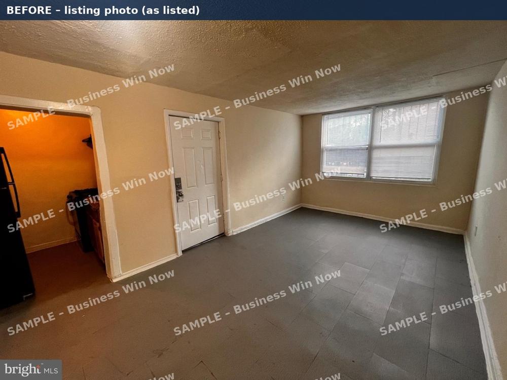 Living room listing photo before staging: empty room with bare floor